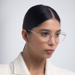Shop PRADA Irregular Eyeglasses in Pale Gold online.