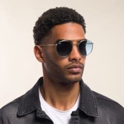 Shop Ray-Ban Round Double Bridge Sunglasses in Gold online.