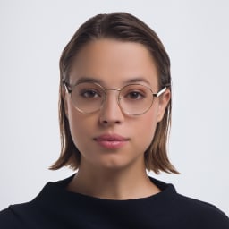 Shop PRADA Round Eyeglasses in Pale Gold online.