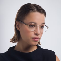 Shop PRADA Round Eyeglasses in Pale Gold online.