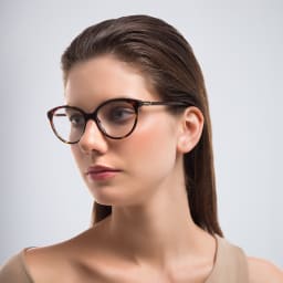 Shop PRADA Round Eyeglasses in Tortoise online.