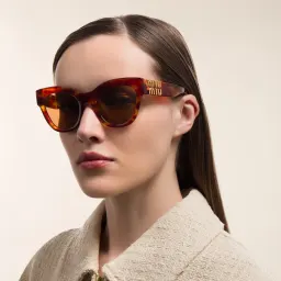 Shop MIU MIU Wide Cat-Eye Sunglasses in Light Havana online.