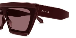 Shop ALAIA The Cut Wide Irregular Sunglasses in Burgundy online.