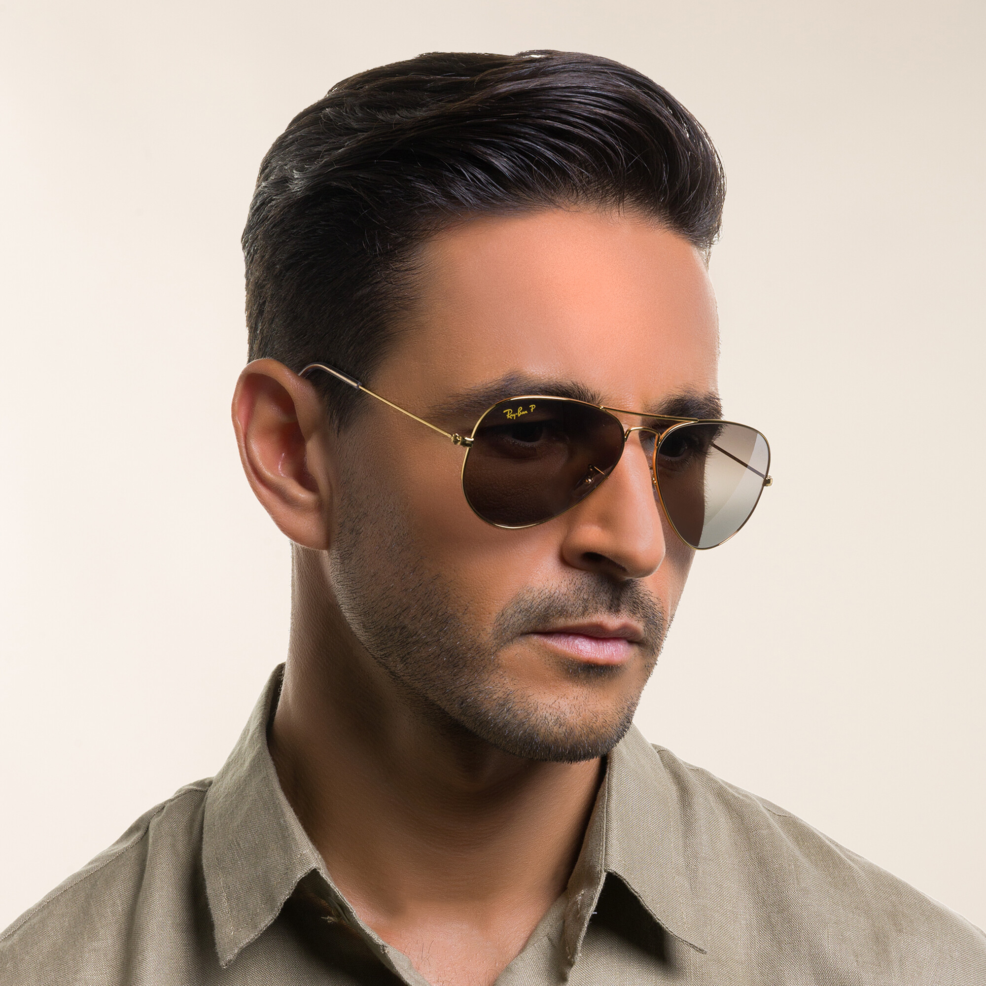 Shop Ray-Ban Unisex Pilot Sunglasses in Gold online.