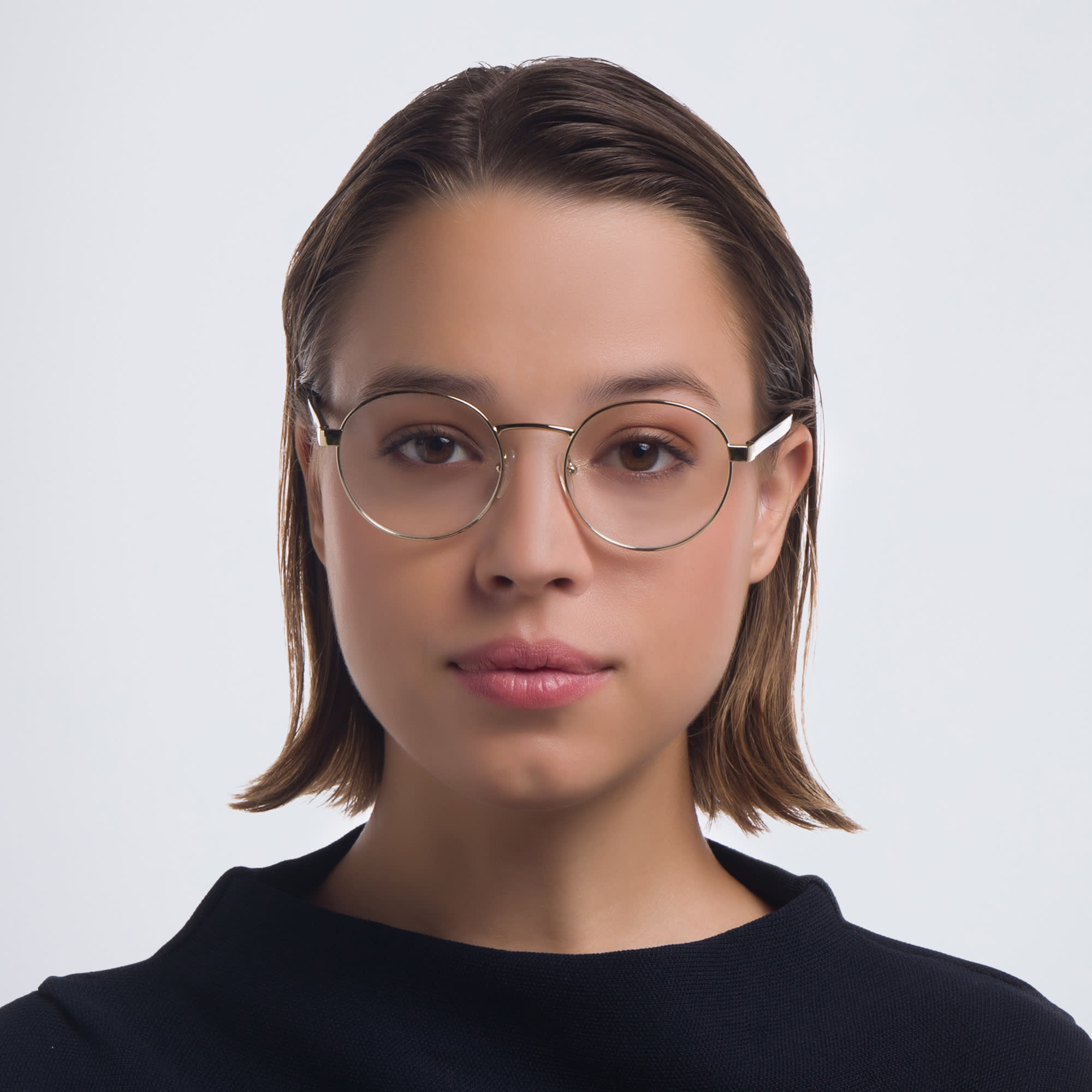 Shop PRADA Round Eyeglasses in Pale Gold online.