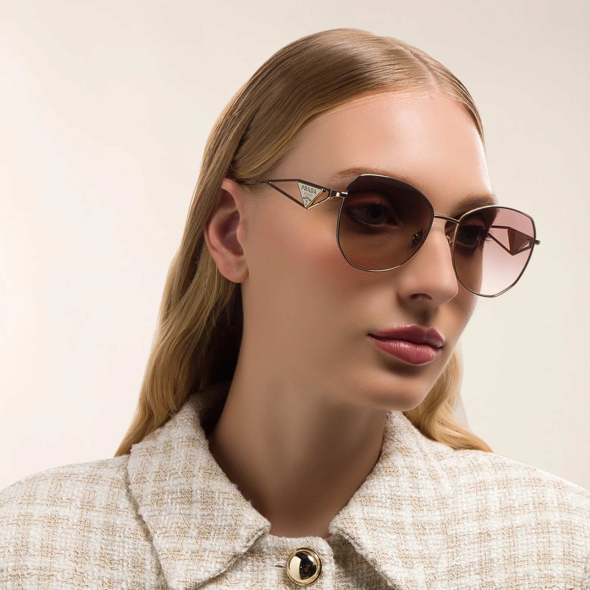 Shop PRADA Irregular Sunglasses in Pale Gold online.