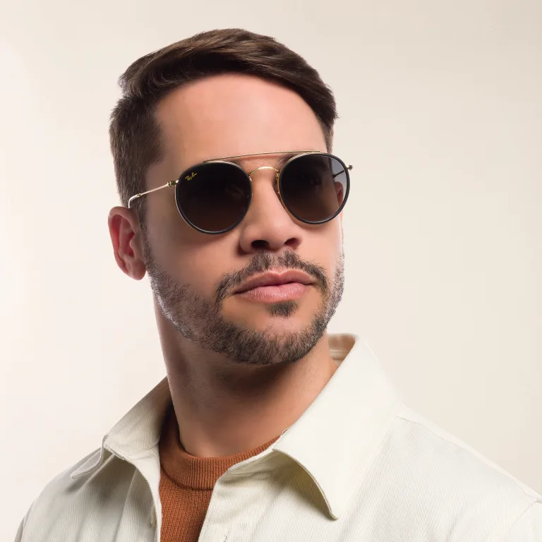 Shop Ray-Ban Unisex Round Sunglasses in Gold online.