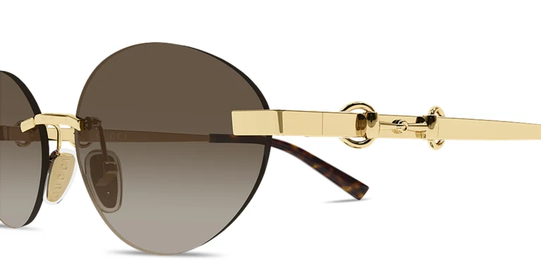 Shop GUCCI Horsebit Rimless Oval Sunglasses in Gold online.