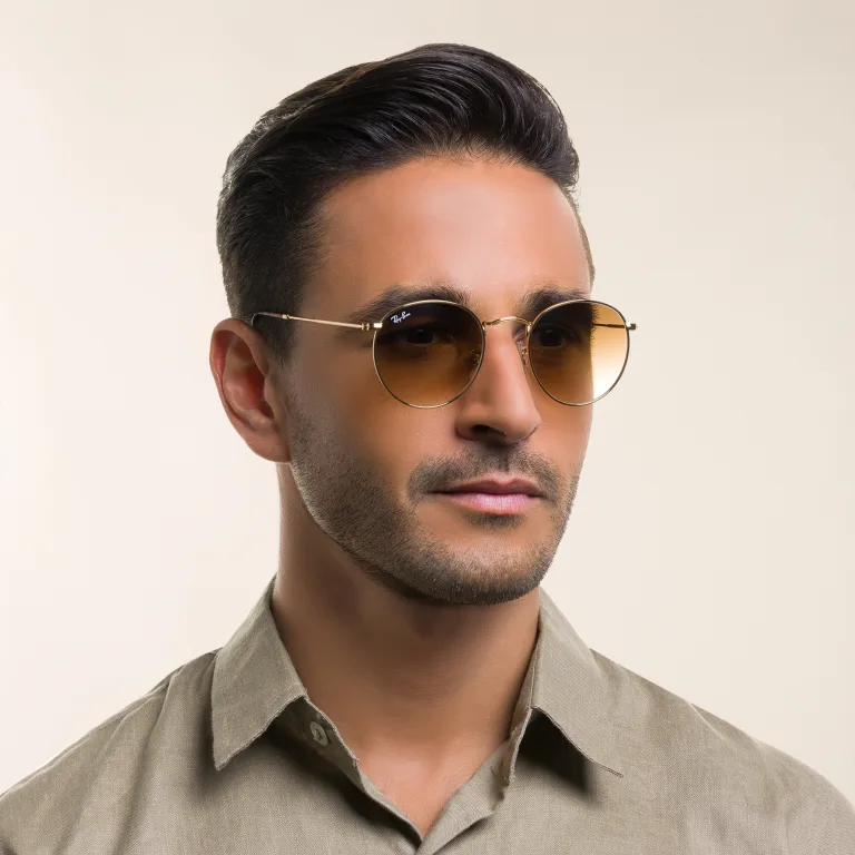 Shop Ray-Ban Round Metal Sunglasses in Gold online.